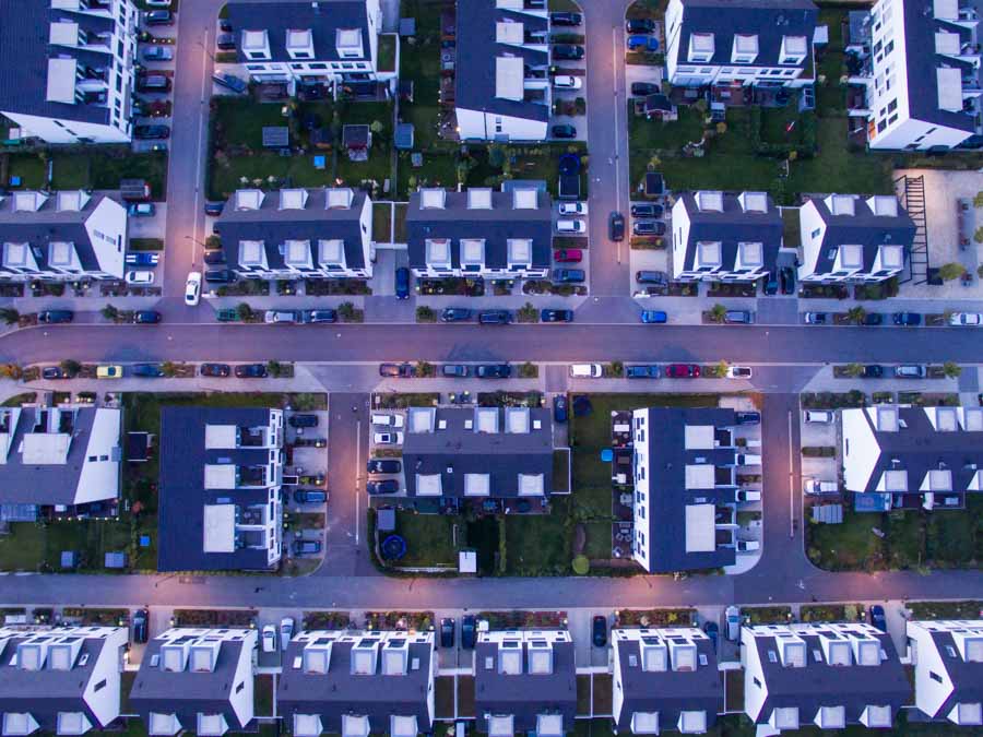 Drone photo of a housing estate at dusk. Arial picture of streets and houses.