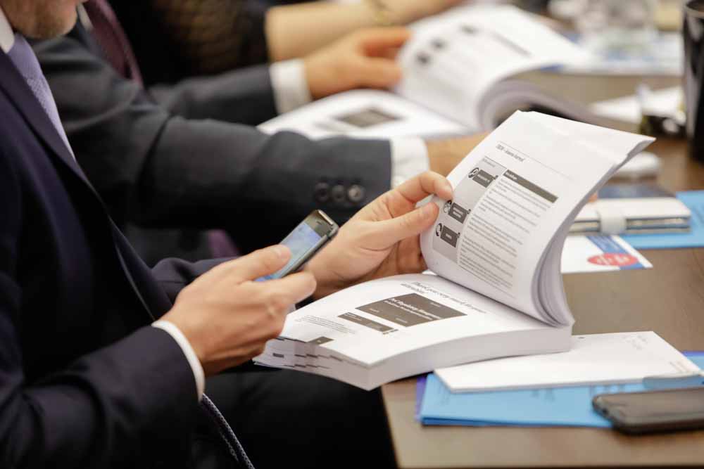 Participants look at their documents during the Handelsblatt event 