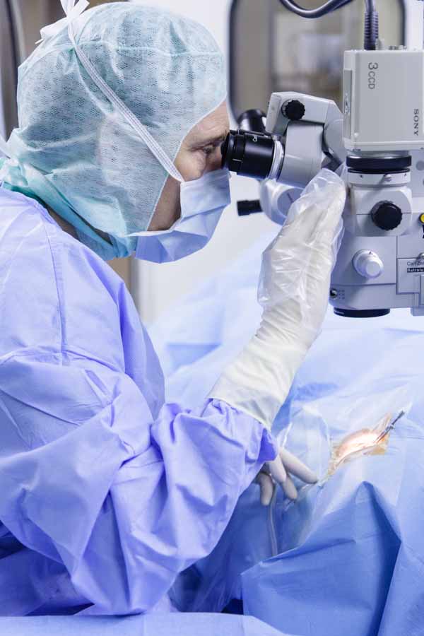 Prof. Kohnen, specialist in eye surgery at the Frankfurt University Hospital, examines the eye through a microscope.
